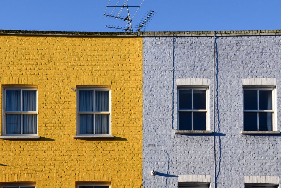 Vibrant yellow and blue townhouses in London, United Kingdom.